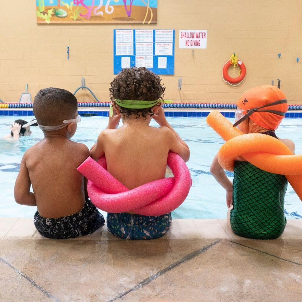 kids sitting by a pool