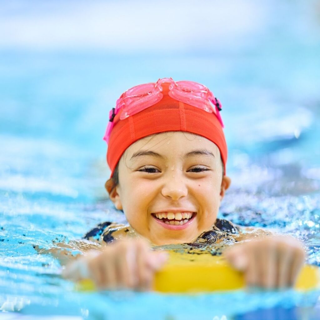 a child using a kick board