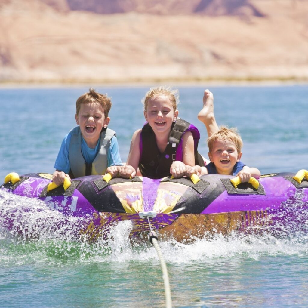 kids in lifejackets on a tube
